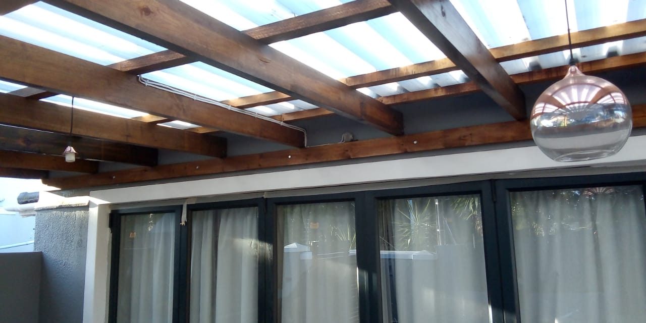 Polycarb roof on a hardwood pergola attached to house