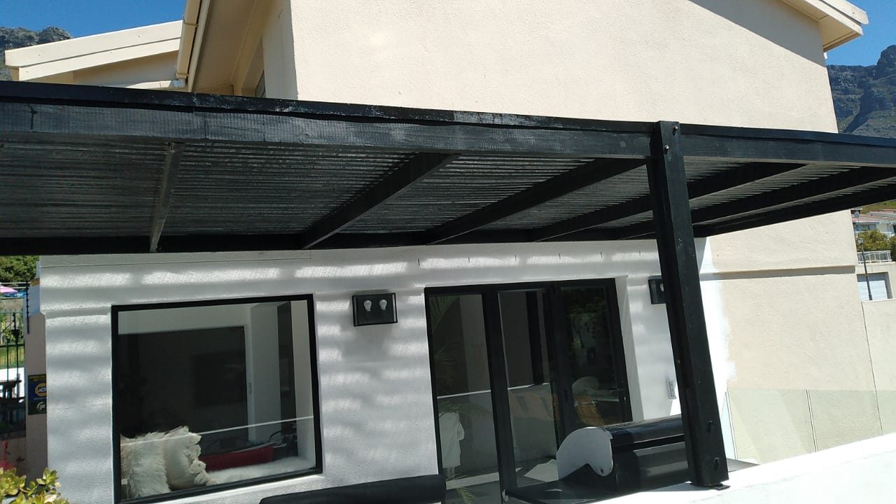 Pine pergola with strip roof painted black