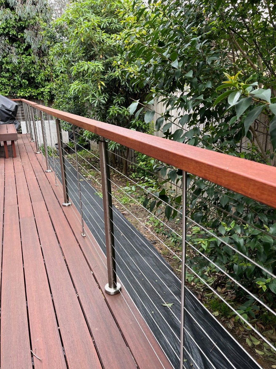 Wire balustrade with steel posts and timber handrail